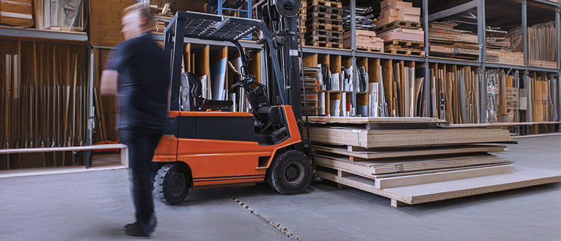 An operator organizing materials on an industrial loading dock
